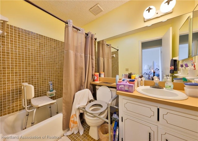 full bathroom with shower / bathtub combination with curtain, vanity, a textured ceiling, tile patterned floors, and toilet