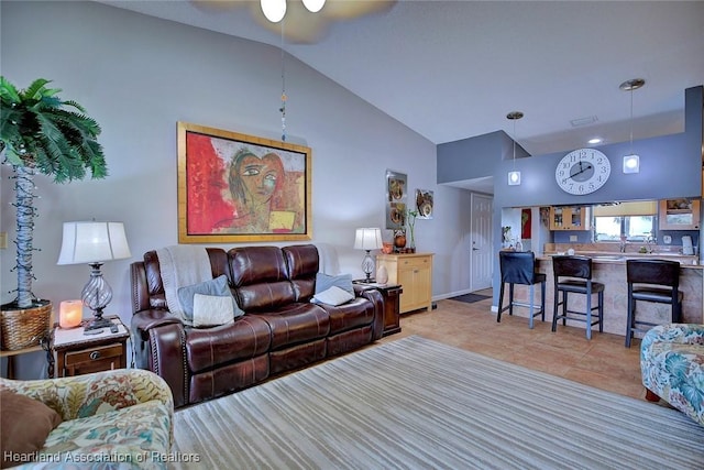 tiled living room featuring ceiling fan and lofted ceiling