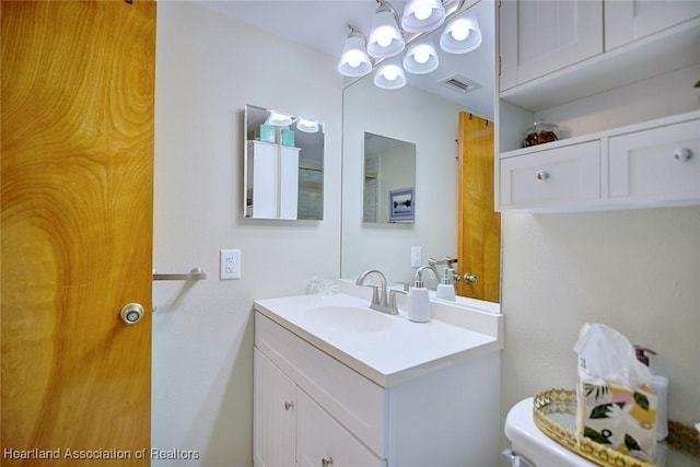 bathroom with toilet and vanity