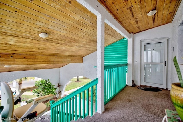 interior space with lofted ceiling, carpet, and wood ceiling