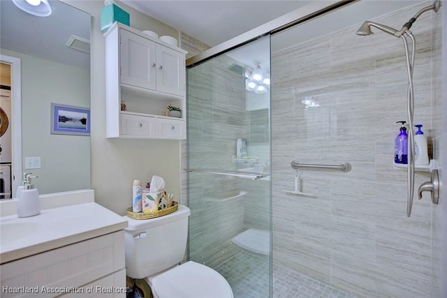 bathroom with toilet, vanity, and an enclosed shower