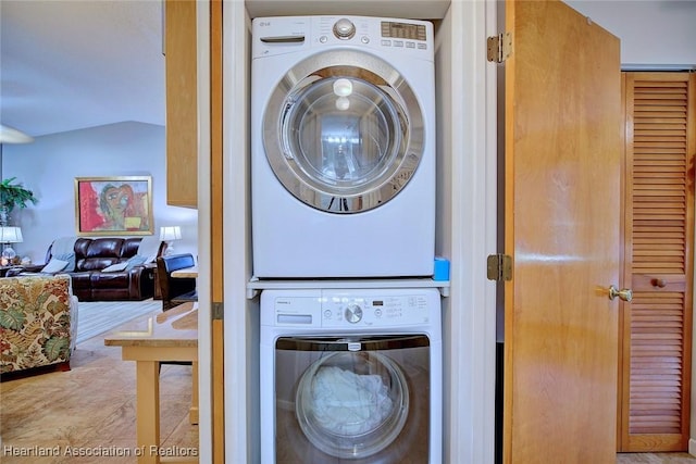 laundry area featuring stacked washer / drying machine