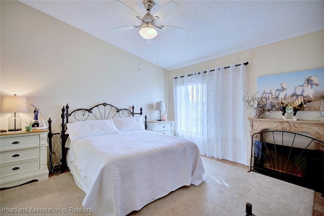 carpeted bedroom featuring ceiling fan, a textured ceiling, and vaulted ceiling