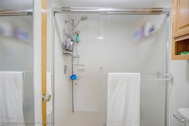 bathroom with a shower with door