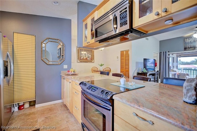 kitchen with ceiling fan, light brown cabinets, appliances with stainless steel finishes, and light tile patterned flooring