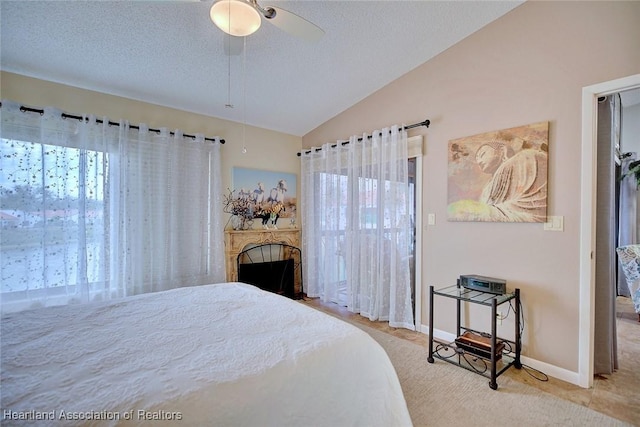 bedroom featuring ceiling fan, a textured ceiling, and vaulted ceiling