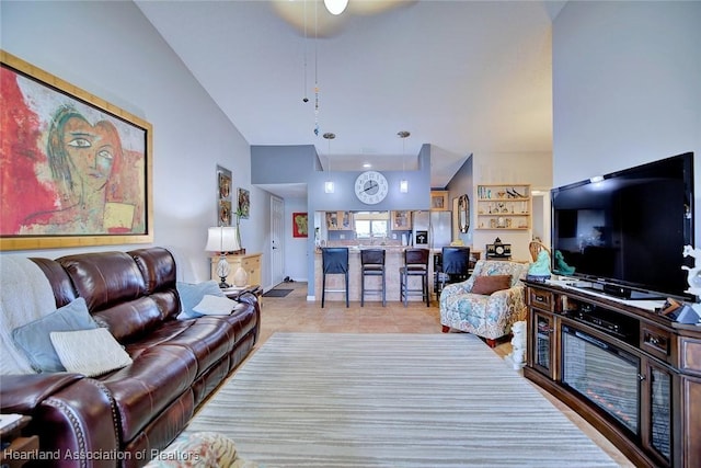 tiled living room with ceiling fan and lofted ceiling