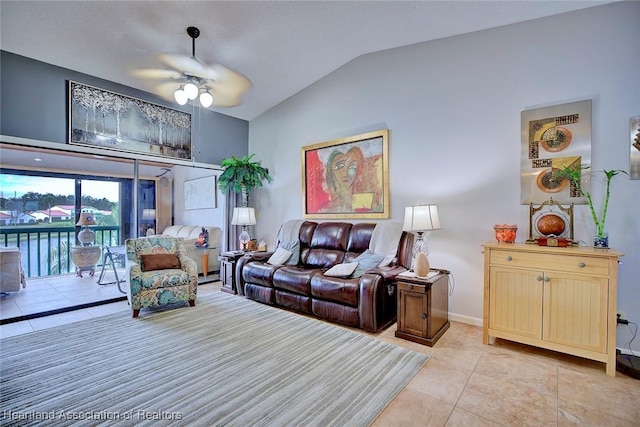 tiled living room featuring ceiling fan and lofted ceiling