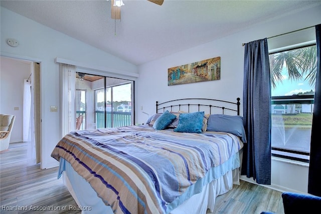 4915 Casablanca Cir Unit H22, Sebring, FL 33870 - bedroom with vaulted ceiling, access to outside, wood finished floors, a ceiling fan, and baseboards