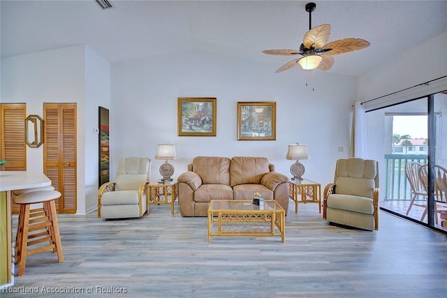 4915 Casablanca Cir Unit H22, Sebring, FL 33870 - living area featuring vaulted ceiling, light wood-style floors, ceiling fan, and baseboards