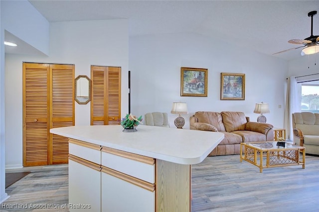 4915 Casablanca Cir Unit H22, Sebring, FL 33870 - kitchen with a ceiling fan, light wood-style floors, light countertops, open floor plan, and vaulted ceiling
