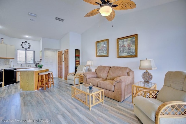 4915 Casablanca Cir Unit H22, Sebring, FL 33870 - living room with light wood-type flooring, a ceiling fan, and high vaulted ceiling