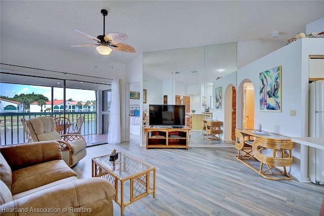 4915 Casablanca Cir Unit H22, Sebring, FL 33870 - living area featuring arched walkways, ceiling fan, lofted ceiling, and wood finished floors