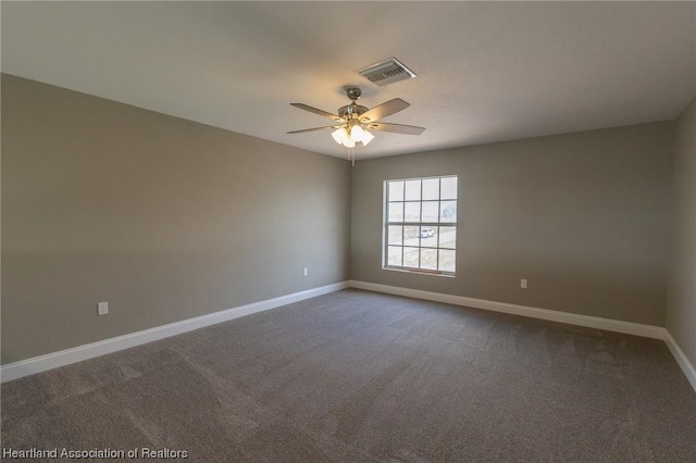 spare room featuring carpet flooring and ceiling fan