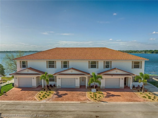 mediterranean / spanish-style house with a water view