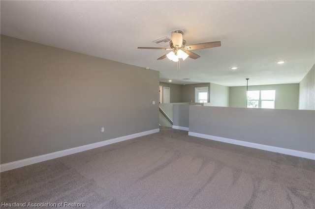 spare room featuring ceiling fan and carpet floors