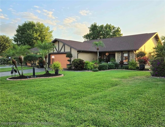 2919 Summertree Dr, Sebring, FL 33872 - view of front of property featuring stone siding, a front yard, stucco siding, concrete driveway, and an attached garage