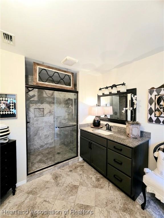 2919 Summertree Dr, Sebring, FL 33872 - bathroom with vanity, a shower stall, and visible vents