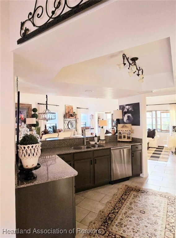 2919 Summertree Dr, Sebring, FL 33872 - bar with stainless steel dishwasher, a sink, and light tile patterned floors
