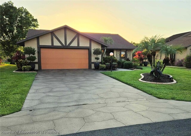 2919 Summertree Dr, Sebring, FL 33872 - english style home with an attached garage, a yard, driveway, and stucco siding
