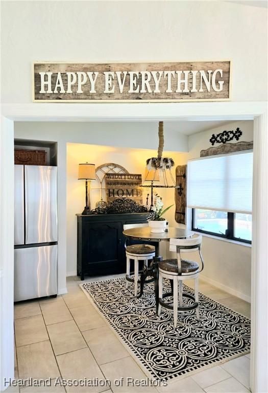 2919 Summertree Dr, Sebring, FL 33872 - tiled dining space featuring baseboards