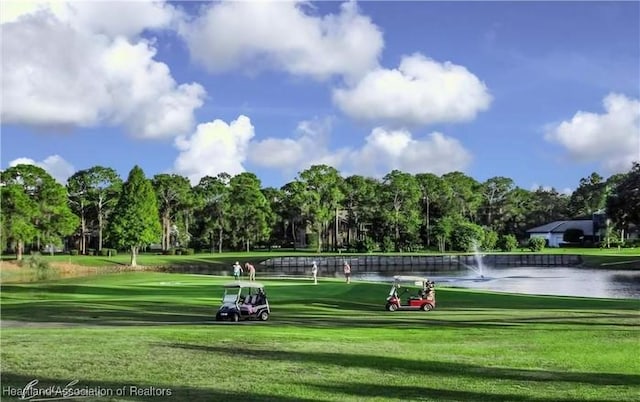 2919 Summertree Dr, Sebring, FL 33872 - view of property's community featuring a lawn, view of golf course, and a water view