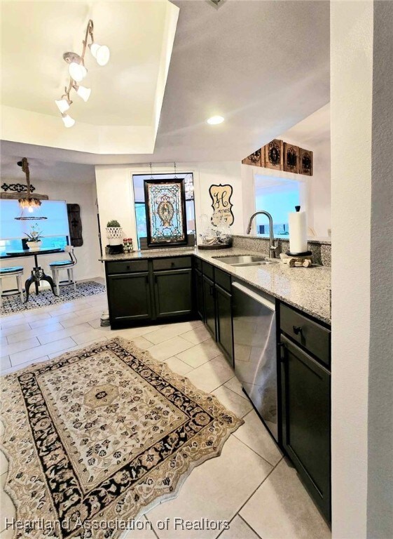 2919 Summertree Dr, Sebring, FL 33872 - bar with light tile patterned floors, a healthy amount of sunlight, a sink, and dishwasher