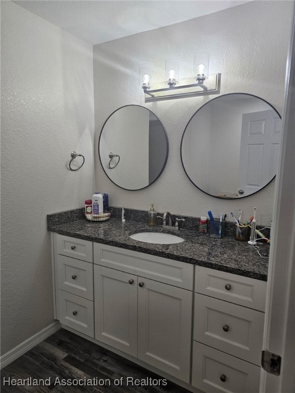 565 Stephens Rd, Wauchula, FL 33873 - bathroom with baseboards, wood finished floors, and vanity