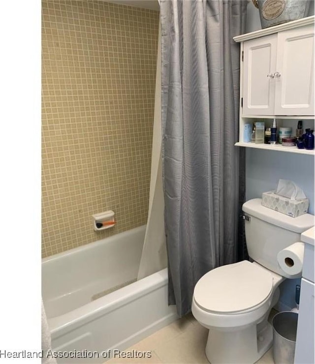 full bathroom with tile patterned flooring, vanity, shower / tub combo with curtain, and toilet