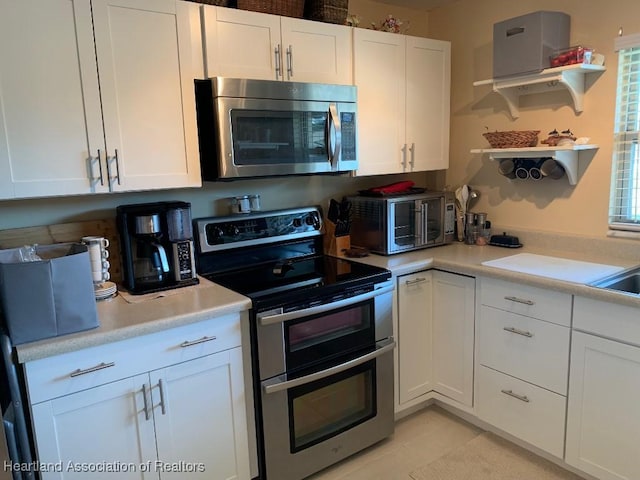 kitchen featuring appliances with stainless steel finishes and white cabinets