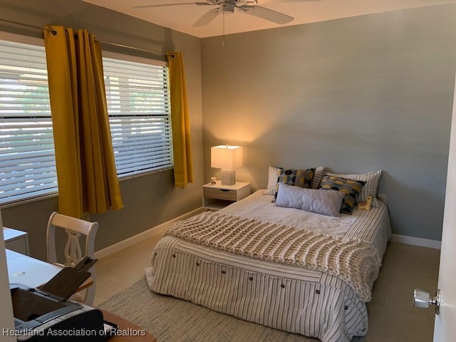 tiled bedroom featuring ceiling fan