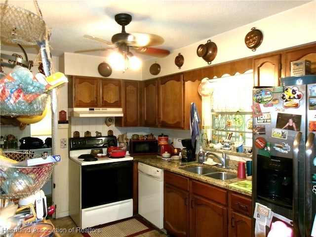 1618 Roberta Ave, Sebring, FL 33870 - kitchen featuring white appliances, under cabinet range hood, ceiling fan, and brown cabinets
