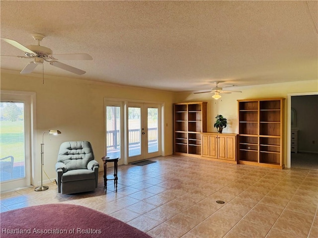 unfurnished room featuring ceiling fan, french doors, light tile patterned floors, and a textured ceiling