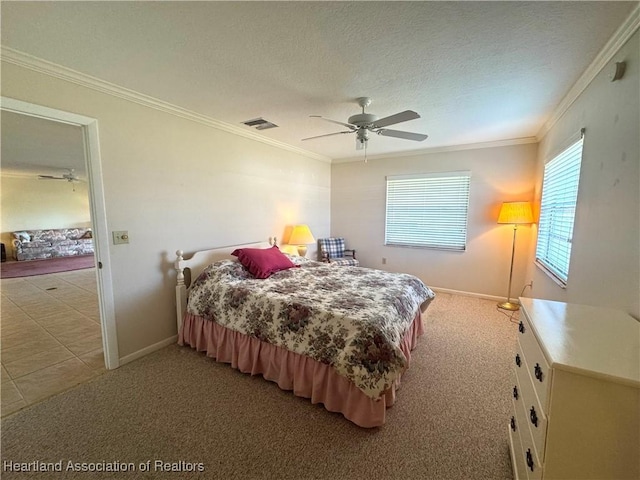 bedroom with light carpet, a textured ceiling, ceiling fan, and ornamental molding