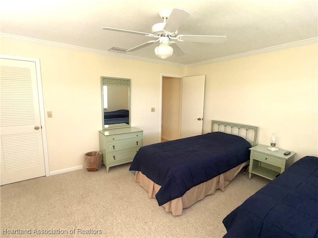 carpeted bedroom with ceiling fan and ornamental molding