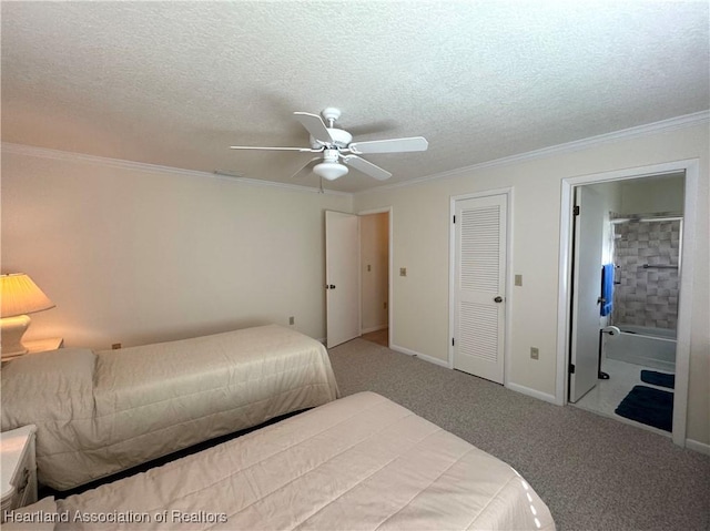 carpeted bedroom featuring ensuite bathroom, a textured ceiling, a closet, ornamental molding, and ceiling fan