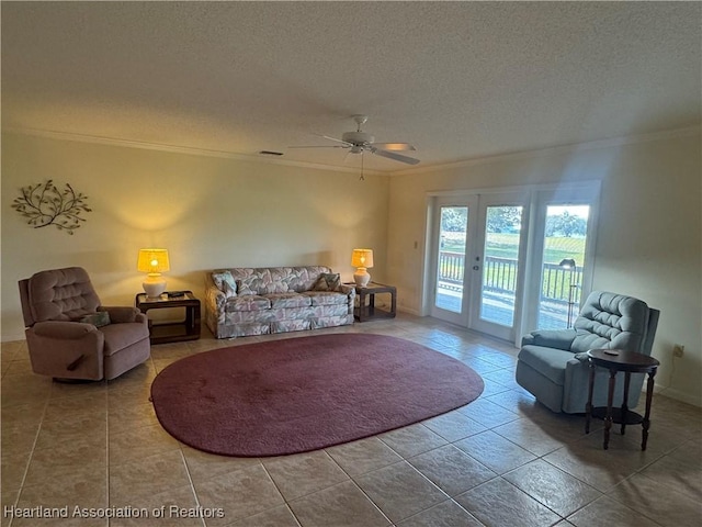 tiled living room with ceiling fan, french doors, ornamental molding, and a textured ceiling