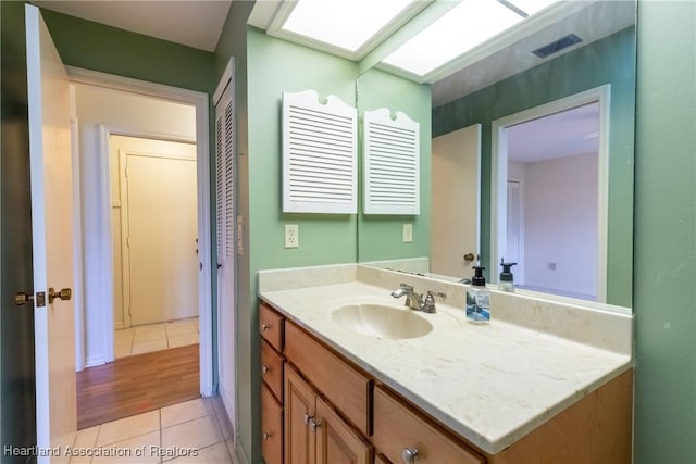 bathroom with tile patterned floors and vanity