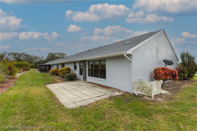 rear view of house with a patio area and a yard