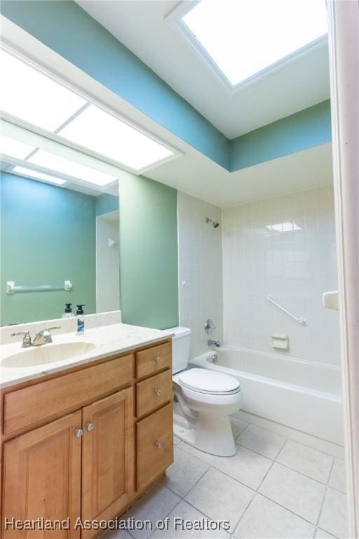 full bathroom featuring tile patterned floors, vanity, tiled shower / bath combo, and toilet