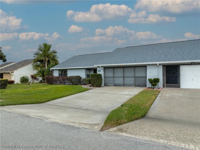 ranch-style home featuring a front lawn and a garage