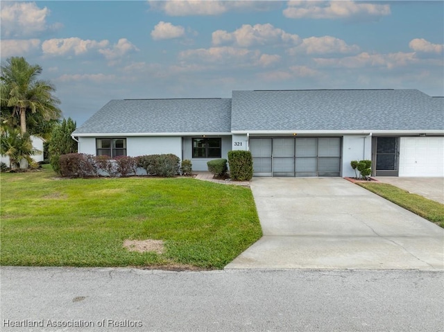 ranch-style home featuring a garage and a front lawn