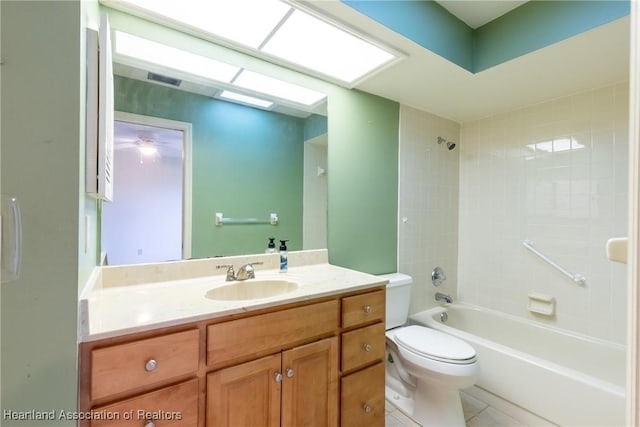 full bathroom featuring vanity, tile patterned floors, tiled shower / bath combo, and toilet