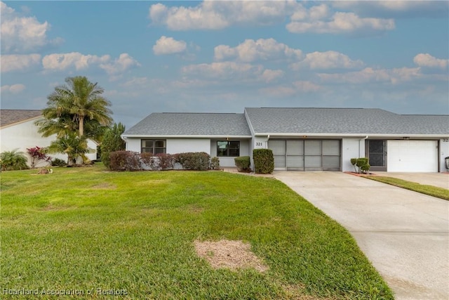 ranch-style house featuring a garage and a front lawn