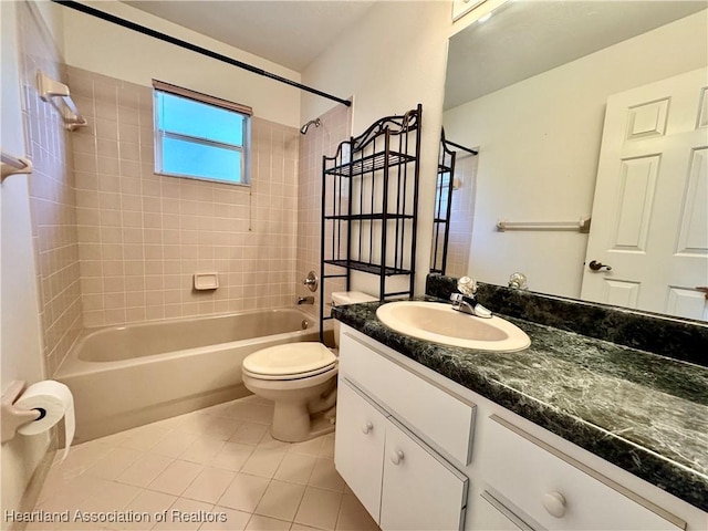 bathroom with toilet, tile patterned flooring, washtub / shower combination, and vanity