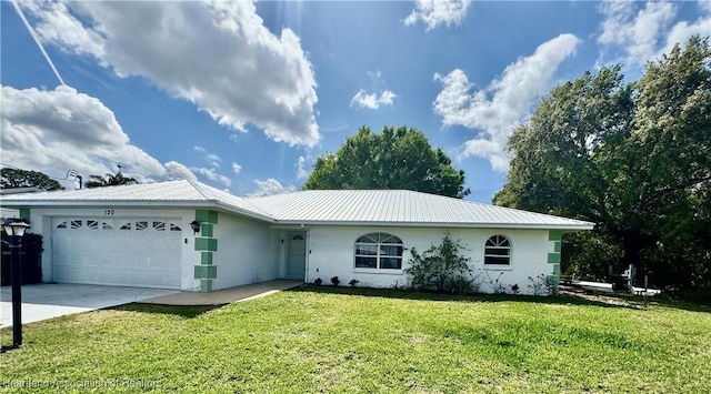 ranch-style home featuring a front yard, metal roof, an attached garage, and stucco siding