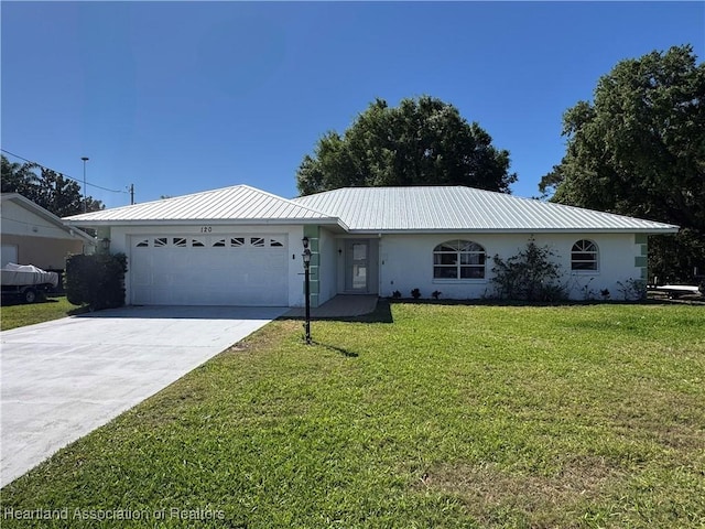 120 Honeycomb Ave, Lake Placid, FL 33852 - ranch-style house featuring stucco siding, concrete driveway, a front yard, an attached garage, and metal roof