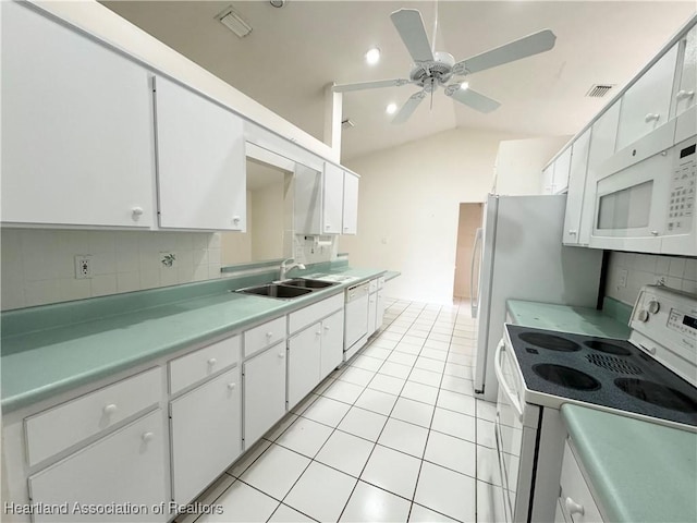 kitchen with light tile patterned floors, white appliances, a sink, visible vents, and white cabinets