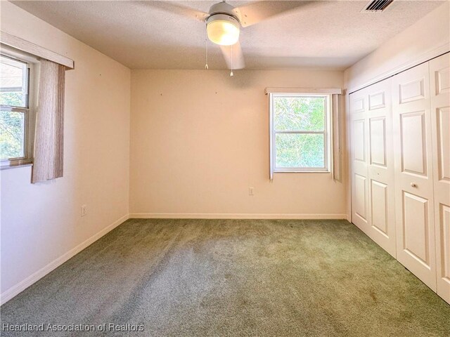 bathroom with double vanity, visible vents, tile patterned flooring, a tile shower, and a sink