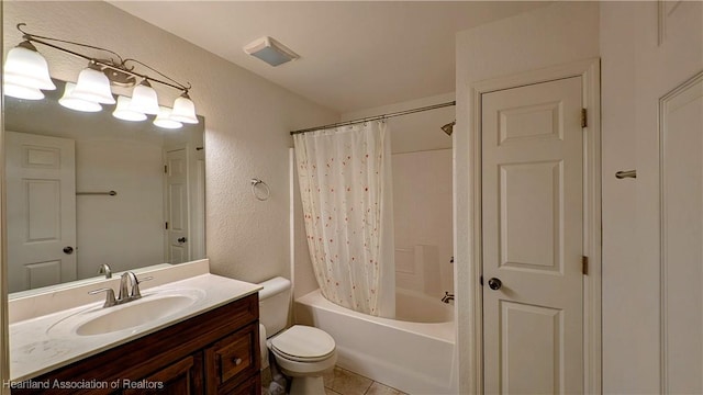 bathroom featuring shower / bath combo, a textured wall, toilet, tile patterned flooring, and vanity